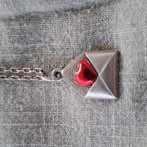 Valentine necklace.Silver in color. Previously owned.